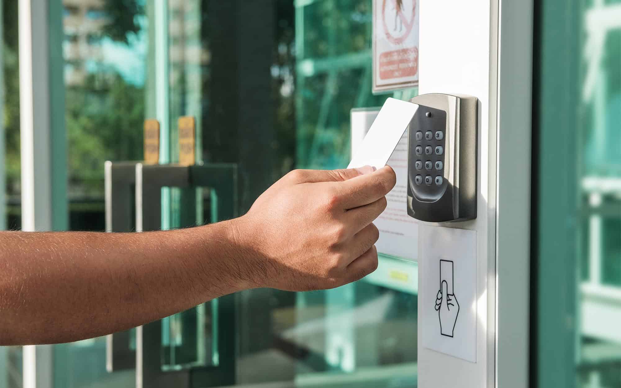 Person using keycard to open door