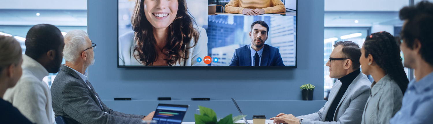 People in hybrid meeting in conference room