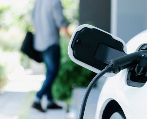 Side view of EV home charger charging car