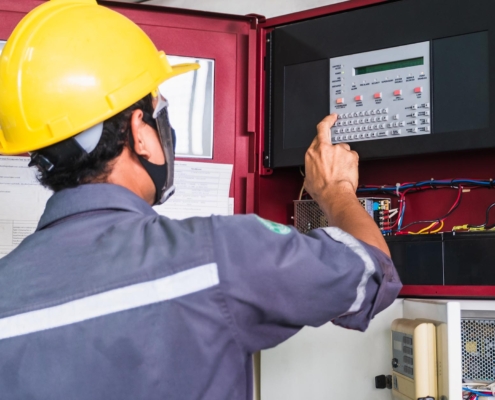 Professional working on commercial fire alarm system